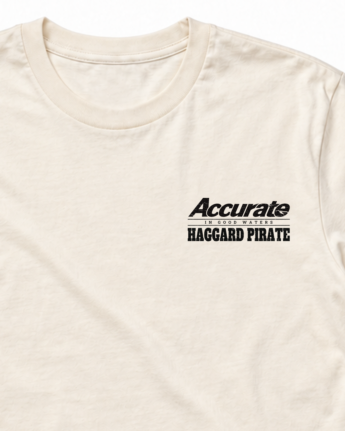 Accurate × Haggard Pirate Natural tee — collar and small left-chest collaboration print detail