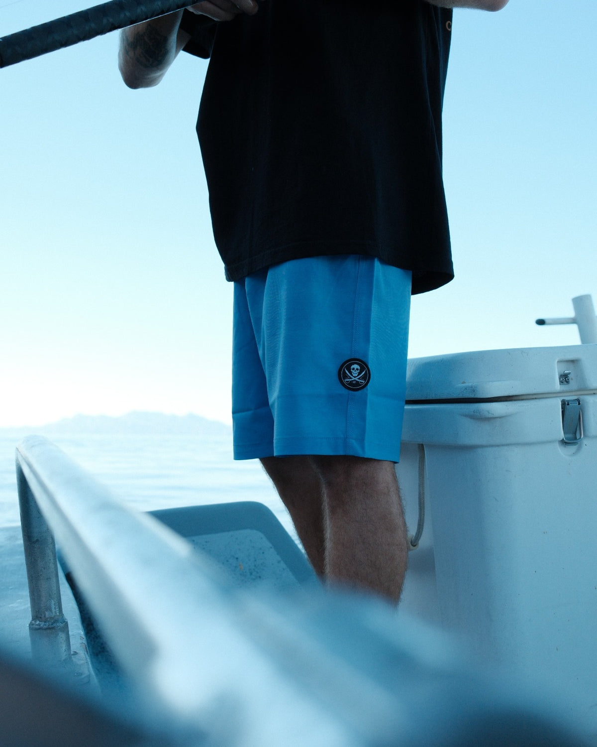 Horizon Hybrid Walkshort — side view and skull & swords patch while fishing in Baja